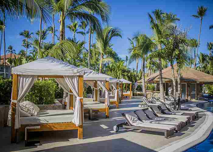 Balinese beds and hammocks around the hotel pool Majestic Colonial Punta Cana