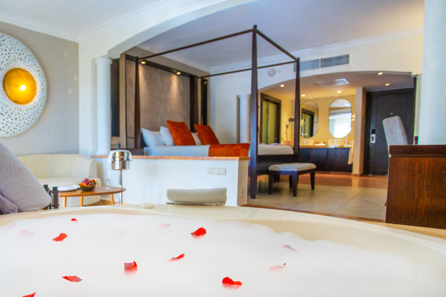 Jacuzzi en la habitación decorado con pétalos de rosa