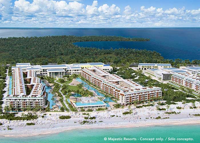 Couple enjoying a swim at the beach of Costa Mujeres at the Majestic Mirage Costa Mujeres All Suite Resort